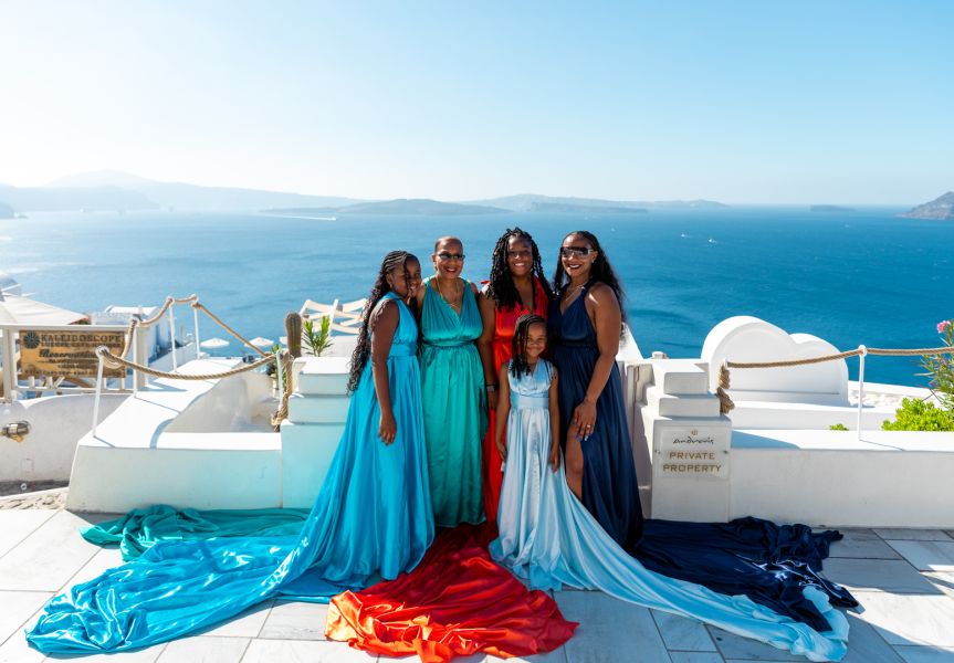Family flying dress photoshoot in Oia